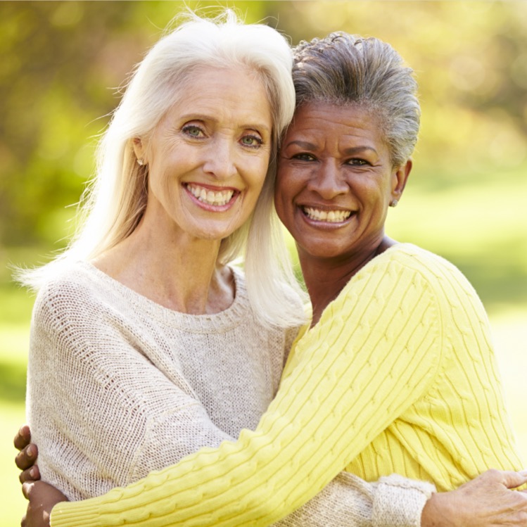 Two senior women hugging